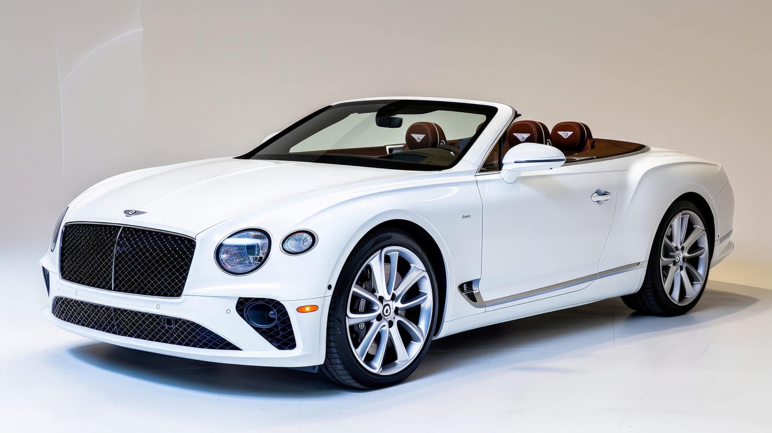 A white luxury convertible, displayed against a white backdrop, highlighting its open-top design and high-end details.